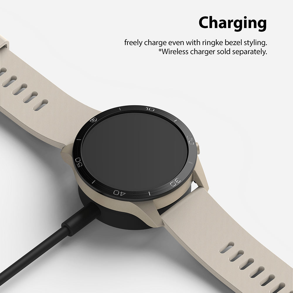 Xiaomi Mi Watch 46mm | Bezel Styling 46-01 - Beige smartwatch with black bezel styling charging on a wireless dock.