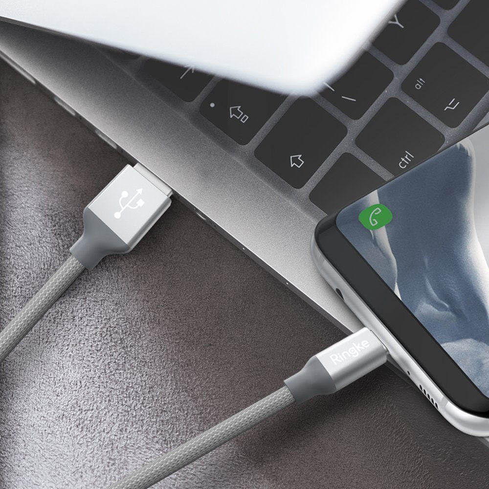 USB Type C Cable - A braided grey USB-C cable connecting a laptop to a smartphone.