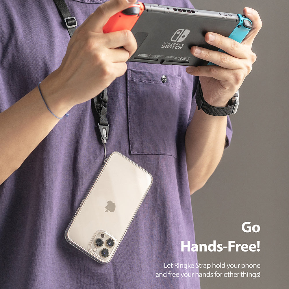 Lanyard Strap | Black - Person in purple shirt wearing a black lanyard holding a phone while playing a Nintendo Switch.