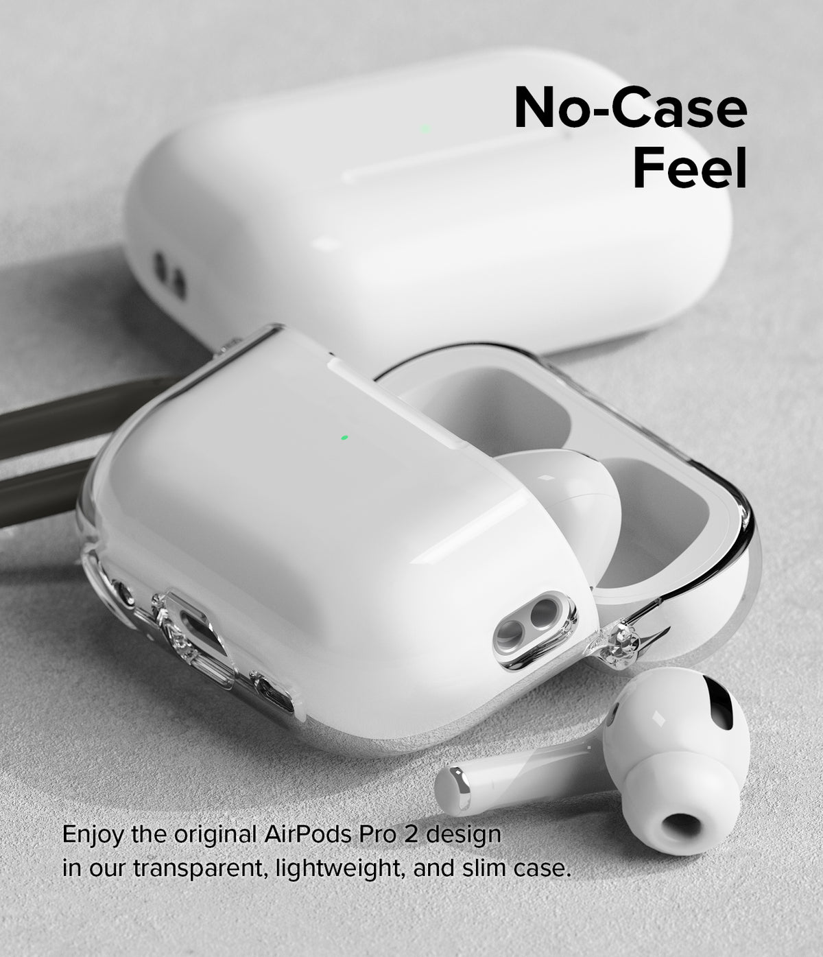 AirPods Pro 2 Case | Hinge Clear - Transparent protective case on AirPods Pro 2 with one earbud resting on a gray surface.