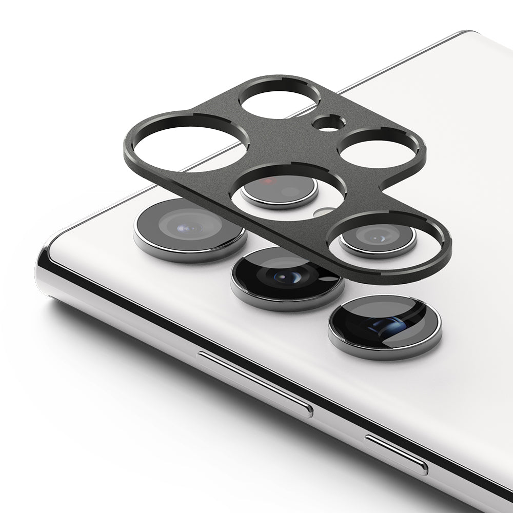 Galaxy S22 Ultra | Camera Styling - Black metal lens protector frame hovering above the white phone's camera array.