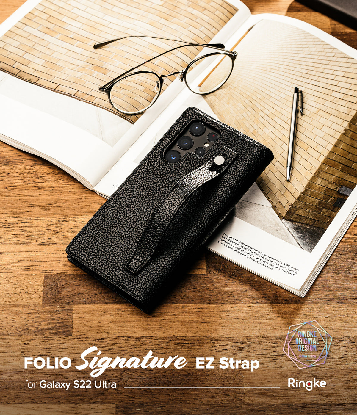 Galaxy S22 Ultra Case | Folio Signature EZ Strap - Black textured leather folio case with strap on an open book.