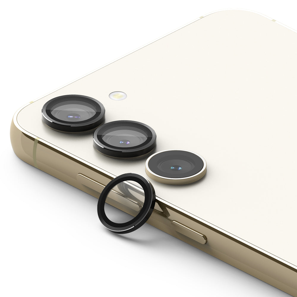 Galaxy S23 / S23 Plus Camera Lens Protector | Camera Lens Frame Glass - Galaxy S23 / S23 Plus Camera Lens Protector - Three black lens covers installed on a cream phone, with one detached.