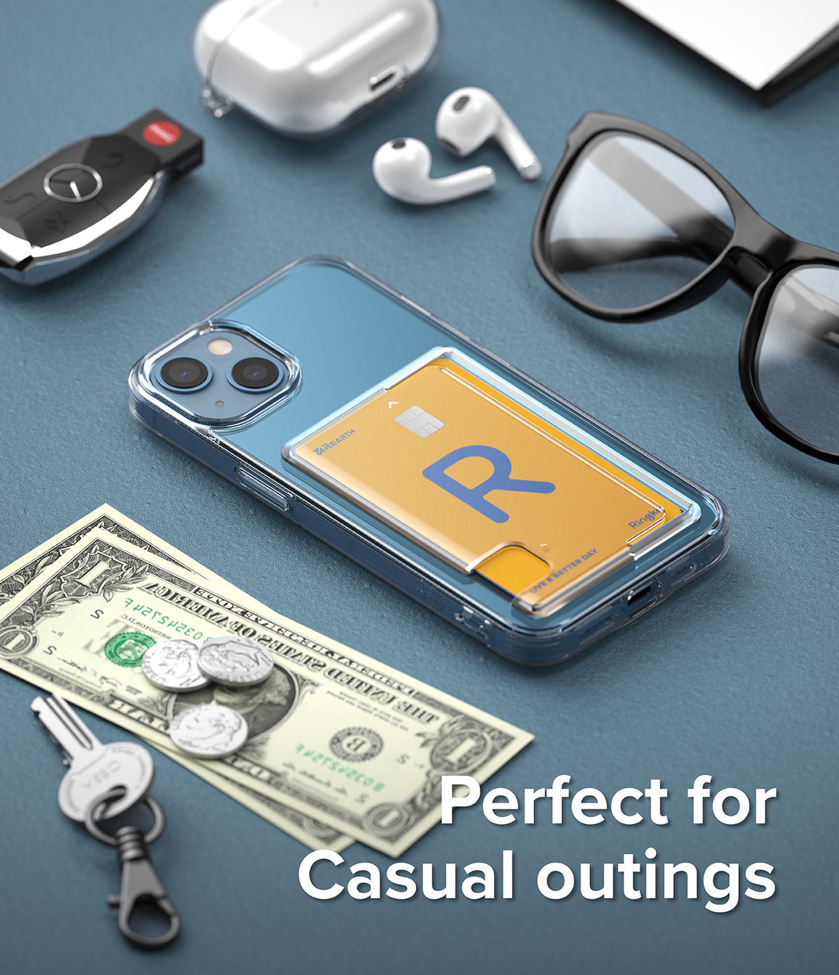 iPhone 13 Case | Fusion Card - Clear phone case with a yellow card holder, surrounded by keys, cash, and accessories.