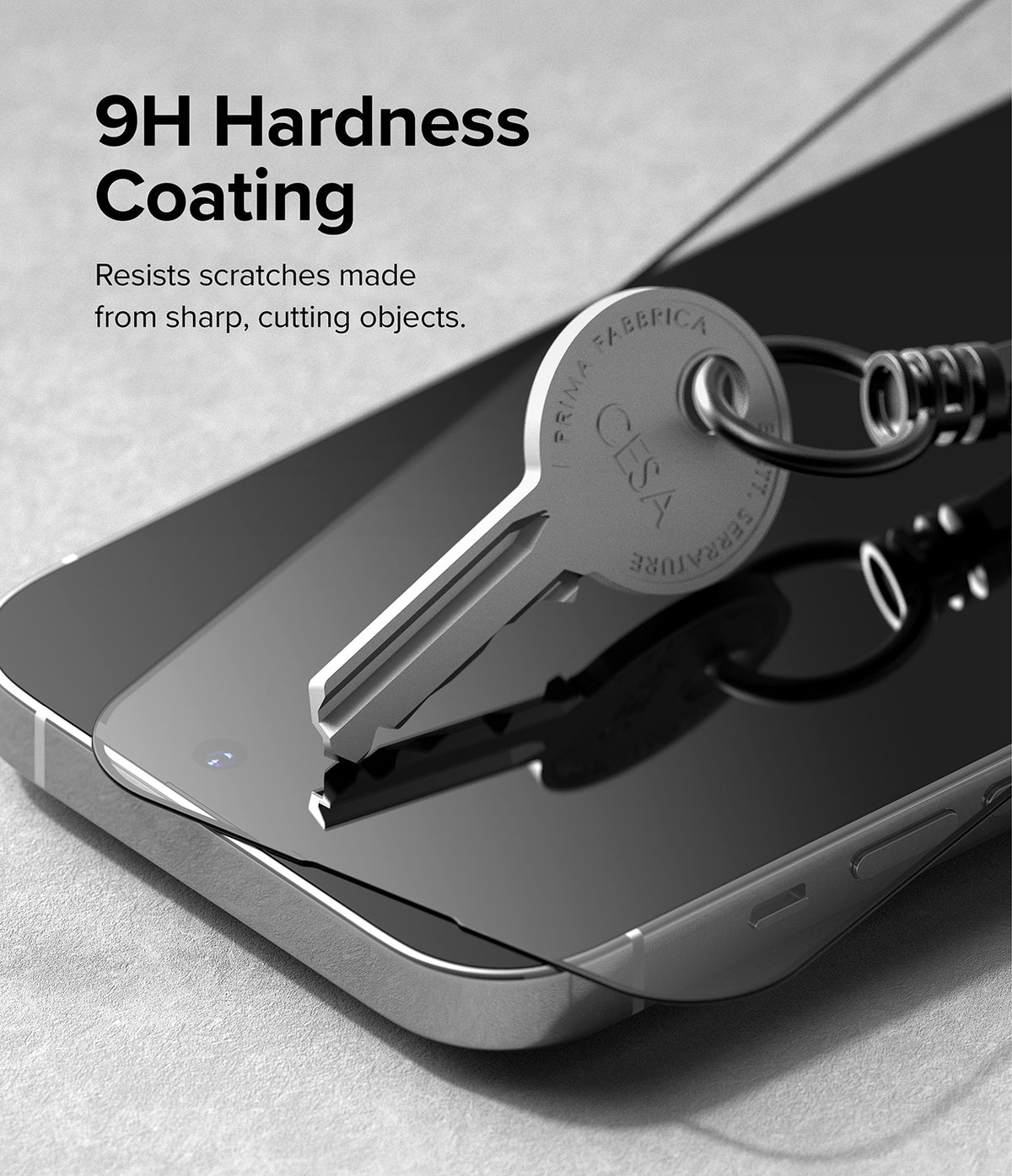 iPhone 14 Pro Screen Protector | Full Cover Glass - iPhone 14 Pro Screen Protector - A metal key pressing against a screen protector on a smartphone to show scratch resistance.