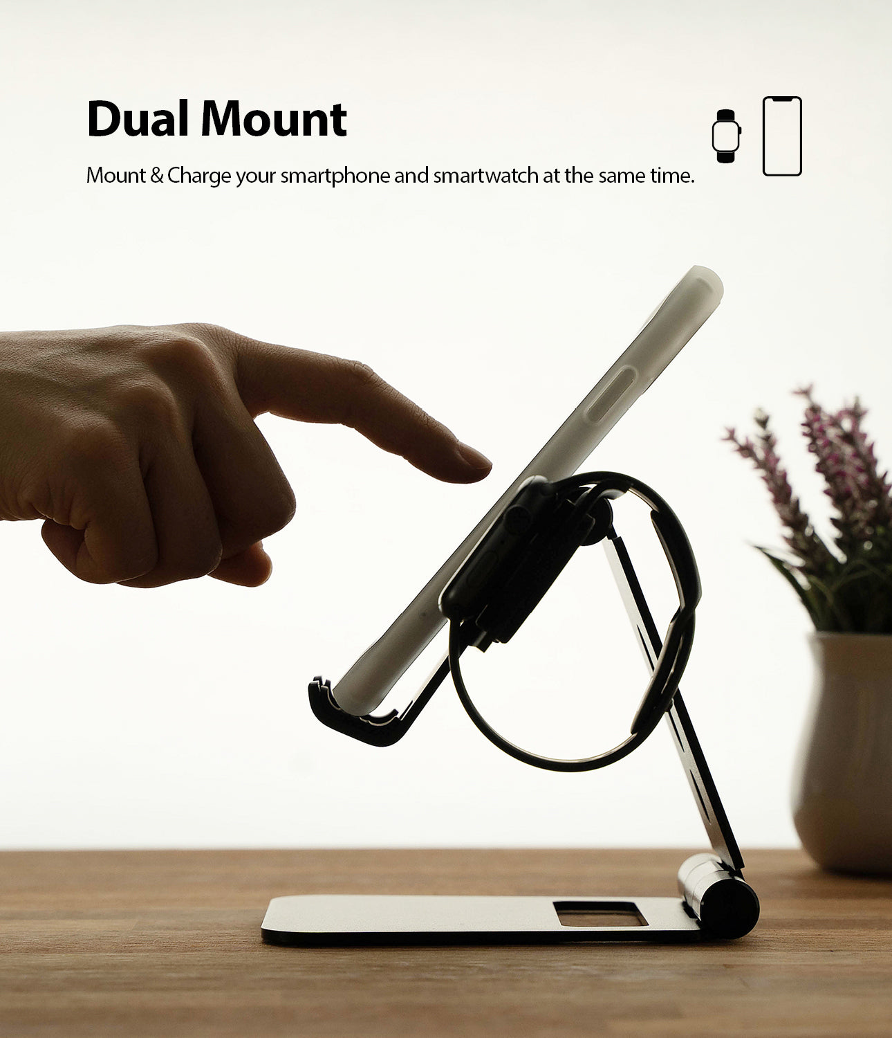 Super Folding Stand for Apple Watch - A finger touches a smartphone mounted on a folding stand that also holds a watch.