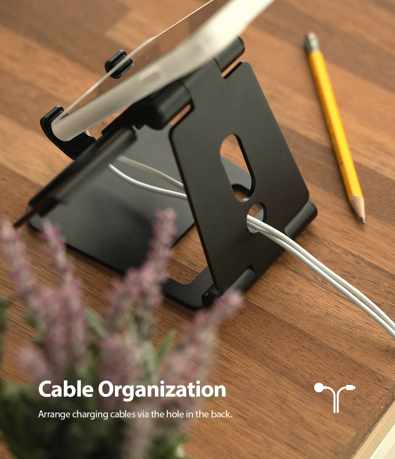 Super Folding Stand for Apple Watch - Black folding stand holding a device with a white charging cable routed through it.