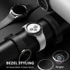 Galaxy Watch 4 Classic 46mm | Bezel Styling - Silver smartwatch with a tachymeter bezel accessory on a black display stand.