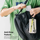 Ring Band Strap - A person in a green shirt attaches a yellow phone strap to a black backpack.