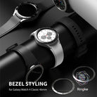 Galaxy Watch 4 Classic 46mm | Bezel Styling - Galaxy Watch 4 Classic 46mm - Three smartwatches with different metallic bezel styling rings displayed on a black stand.