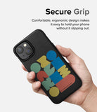 iPhone 14 Case | Onyx Design - Hand holding a black phone case with colorful geometric shapes and textured finish.