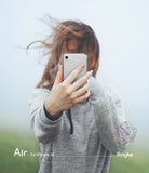 iPhone SE 2022 5G / SE 2020 / 8 Case | Air - Person holding a clear iPhone case in front of their face outdoors.