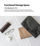 2-Way Bag - A black zippered pouch next to a notebook, glasses, a glasses case, and wireless earbuds on a white surface.