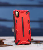 iPhone XS Case | Dual-X [DX] - Rugged red and black protective phone case standing upright on a textured surface.