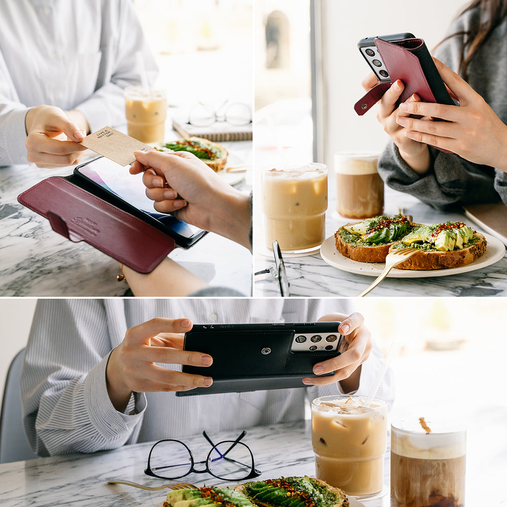 Galaxy S21 Ultra Case | Folio Signature+ - A person uses a maroon and black leather folio phone case at a cafe.