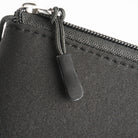 Cushion Pouch - Close-up of a black fabric pouch featuring a sturdy zipper with a textured, rectangular pull tab.