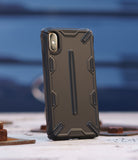 iPhone XS Case | Dual-X [DX] - Matte black rugged protective phone case with geometric accents standing on a textured surface.