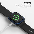 Apple Watch Series 6 / 5 / 4 / SE (44mm) | Bezel Styling - Apple Watch with blue bezel styling charging on a wireless puck.