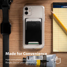 Card Holder | Slot [Solid - 2 Cards] [1 Pack] - Black card holder attached to a clear phone case on a wooden desk.