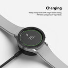 Galaxy Watch 4 Classic 46mm | Bezel Styling - Smartwatch with textured bezel accessory charging on a wireless dock.