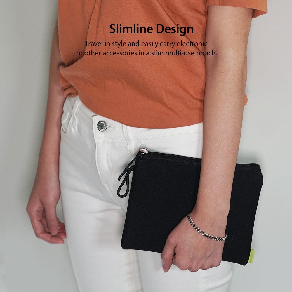 Cushion Pouch - A person in an orange shirt and white jeans holds a slim, black zippered pouch in their hand.