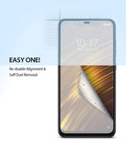 Pocophone F1 Screen Protector | Dual Easy Film - Pocophone F1 Screen Protector - Smartphone with a partially peeled screen film showing dust removal and alignment grid.