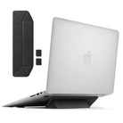 Laptop Stand - A foldable black adhesive laptop stand attached to a silver laptop, with extra pieces shown separately.