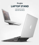 Laptop Stand - Two views of a silver laptop elevated by a compact, black adhesive stand on a white background.