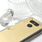 LG G6 Case | Mirror - Gold reflective phone case with camera cutout next to a large decorative glass diamond.