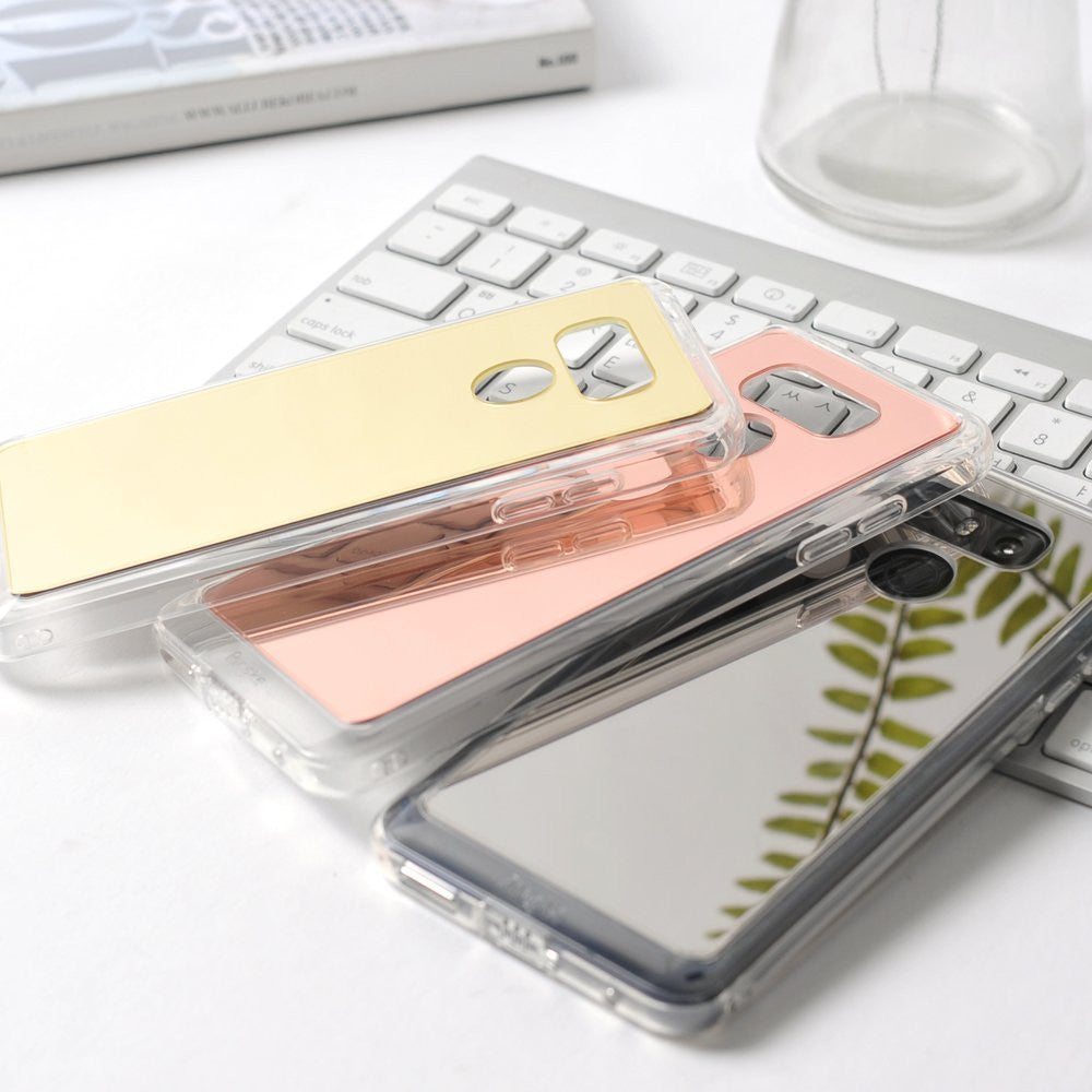LG G6 Case | Mirror - Three reflective mirror phone cases in gold, rose gold, and silver stacked on a white keyboard.
