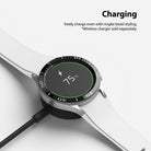 Galaxy Watch 4 Classic 42mm | Bezel Styling - A Galaxy Watch 4 with a black bezel styling accessory charging wirelessly.