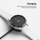 Galaxy Watch 4 Classic 42mm | Bezel Styling - Galaxy Watch 4 Classic 42mm | Galaxy Watch 4 with a black Ringke bezel styling charging on a wireless dock.