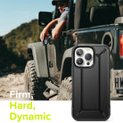 iPhone 13 Pro Case | DX - Black rugged phone case shown in foreground with a person in an off-road vehicle in the background.