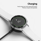Galaxy Watch 4 Classic 46mm | Bezel Styling - A Galaxy Watch 4 with a black bezel accessory charging on a wireless dock.