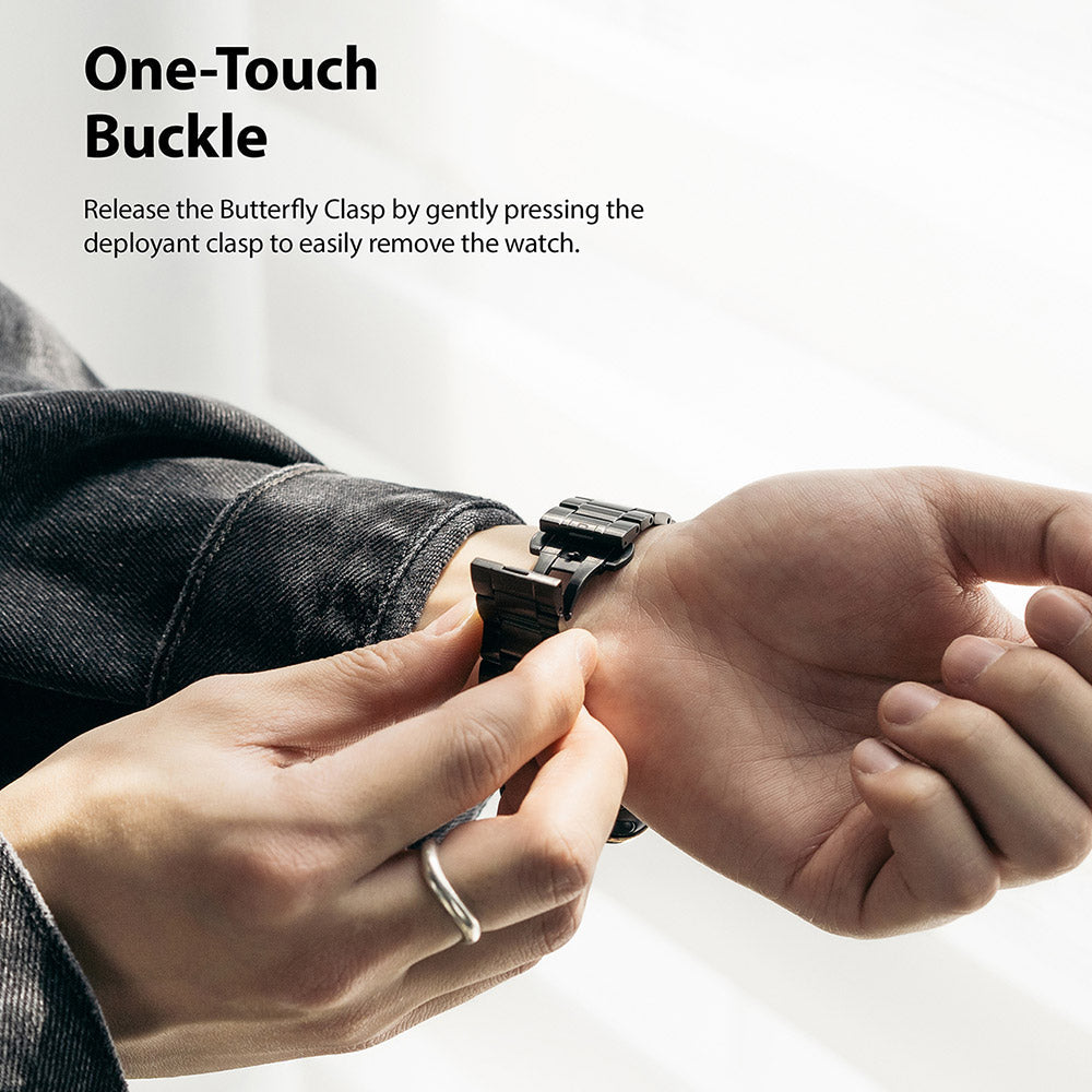 Apple Watch 49·46·45·44·42 mm | Metal One Band - Hands pressing the butterfly clasp on a black metal watch band.