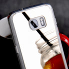 Galaxy S7 Case | Mirror - Reflective silver phone case leaning against a red mug, showing a clear mirror finish.