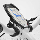 Spider Grip Bike Mount - Smartphone secured in a black silicone spider-style holder attached to white bicycle handlebars.