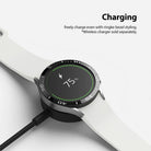Galaxy Watch 5/4 40mm | Bezel Styling - Smartwatch with black bezel styling charging on a wireless dock showing 75% battery.