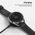 Galaxy Watch 3 (45mm) | Bezel Styling - A Galaxy Watch 3 with a metal bezel ring charging wirelessly on a black dock.