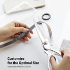 Ring Band Strap - Hands cutting a grey fabric strap with scissors next to a phone case and ring accessory.