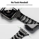 Apple Watch 49·46·45·44·42 mm | Metal One Band - Close-up of a black metal watch band attaching to an Apple Watch via a dual spring system.