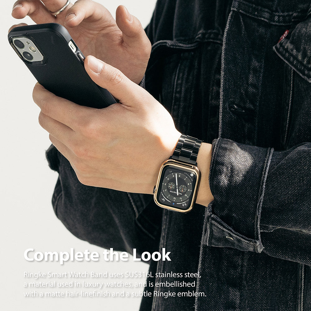 Apple Watch 49·46·45·44·42 mm | Metal One Band - Person wearing a black metal watch band and gold case on an Apple Watch.