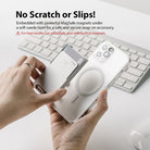 Card Holder | Magnetic Slot - Hands attaching a magnetic card holder to a clear phone case above a computer keyboard.