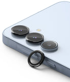 Galaxy A55 / A35 | Camera Lens Frame Glass - A light blue smartphone with three camera lenses and one loose black lens ring.