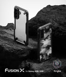 Galaxy A36 / A56 Case | Fusion-X - Two Fusion-X phone cases on dark rock, one clear and one with a black camo pattern.