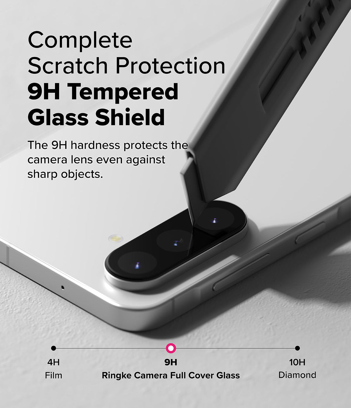 Galaxy A56 / A36 | Camera Glass - A utility knife blade presses against a phone camera lens protected by 9H tempered glass.