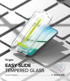Galaxy A56 / A36 Screen Protector | Easy Slide Tempered Glass - Galaxy A56 / A36 Screen Protector - Easy Slide installation tool applying a tempered glass film onto a smartphone.