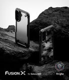 Galaxy A57 5G Case | Fusion-X - Two rugged Fusion-X phone cases displayed on dark, textured volcanic rock.