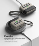 AirPods 3 Silicone Case | Ice Box - Two-tone beige and black AirPods cases with carabiners charging on a wireless pad.