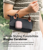 AirPods 5 / 4 Case | Air - A pink translucent AirPods 4 case attached to a black handbag with a black metal carabiner.